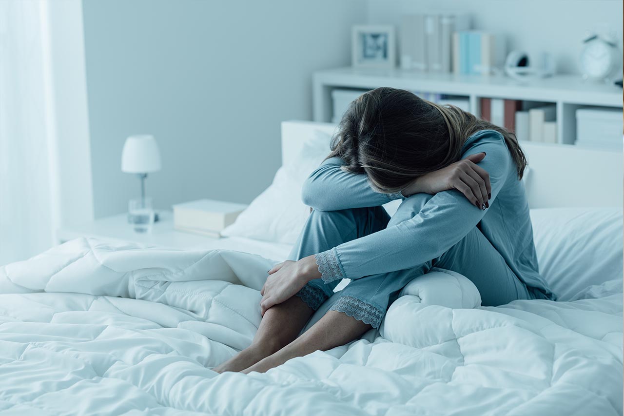 woman with depression in bed